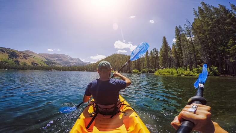 Summer travel in USA: POV kayaking in lake recreational area