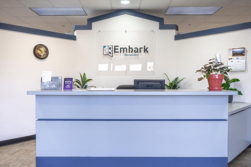 Front Desk of Embark Recovery with Embark Logo sign on wall