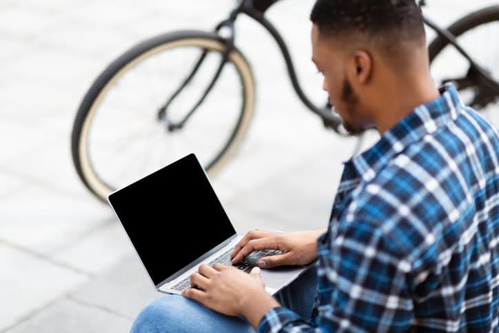 Student using laptop, sitting
